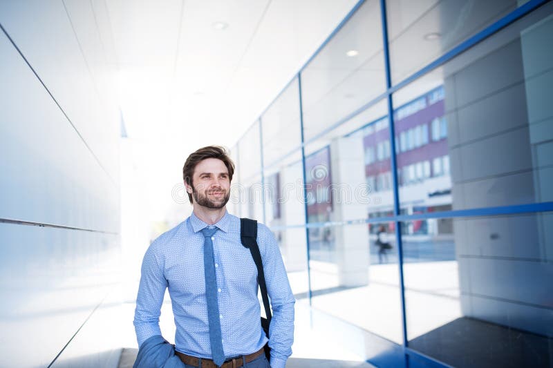 Handsome businessman walking on city street, going to a office. Manager smiling, outdoor in urban setting. Handsome businessman walking on city street, going to a office. Manager smiling, outdoor in urban setting.