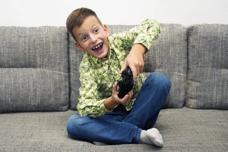 Netter Junge, der zu Hause Videospiele spielt lizenzfreie stockfotos Netter Junge, der zu Hause Videospiele spielt lizenzfreie stockfotos