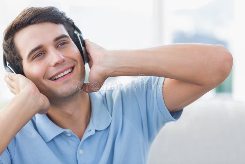 Cheerful man enjoying music with headphones. Cheerful man enjoying music with headphones