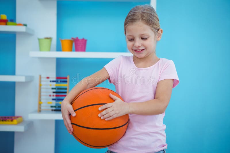 Nettes Mädchen, das Korbball hält lizenzfreies stockfoto Nettes Mädchen, das Korbball hält lizenzfreies stockfoto