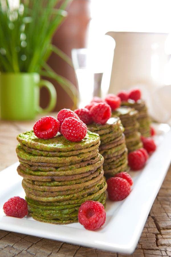 Nettle pancakes with raspberries stock photos Nettle pancakes with raspberries stock photos