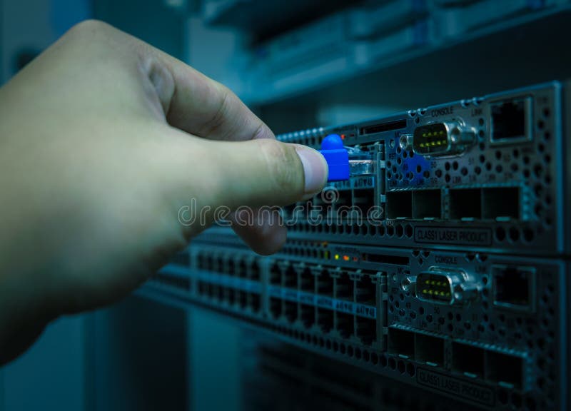 Network engineer plug lan cable to ethernet switch royalty free stock image