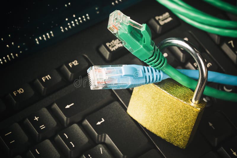 Network ethernet cables in padlock on computer keyboard. Internet data privacy information security concept. Toned image stock photos