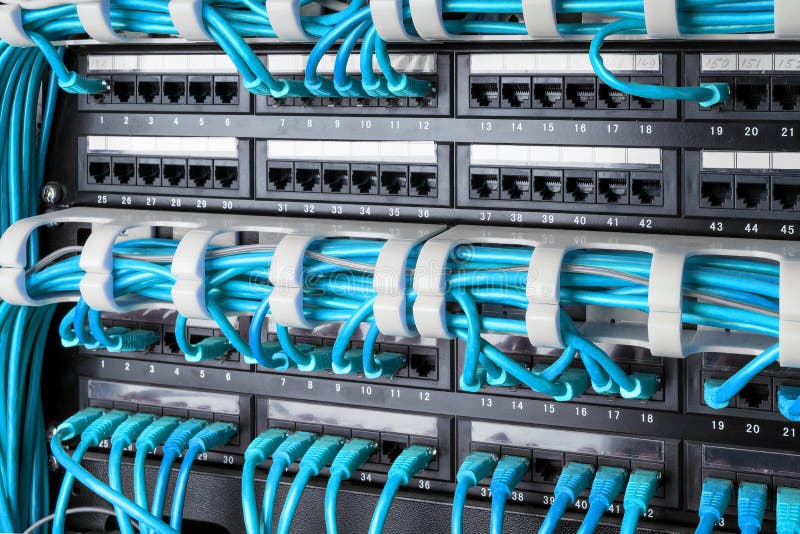 Network panel, switch and internet cable in data center. Black switch and blue ethernet cables, Data Center Concept. stock photos