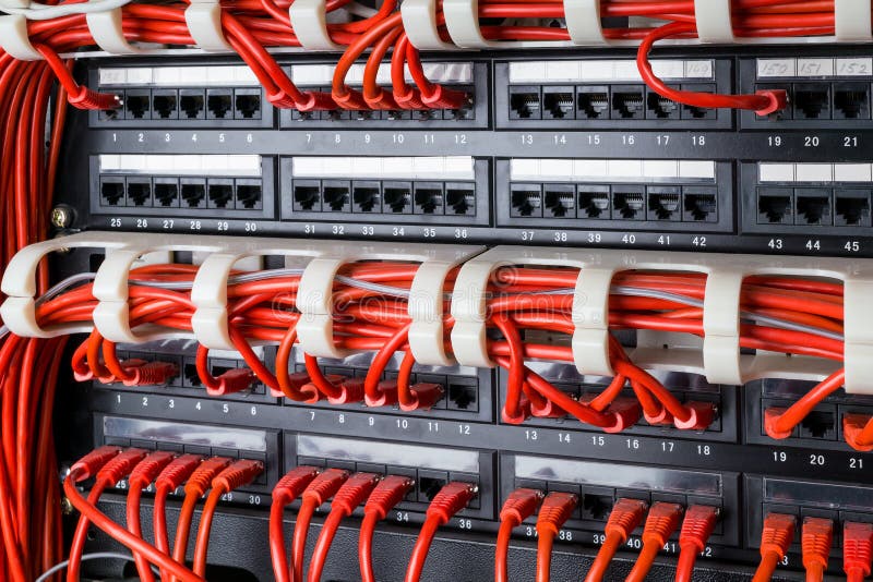Network panel, switch and red internet cable in data center. Black switch and red ethernet cables, Data Center Concept. stock photos