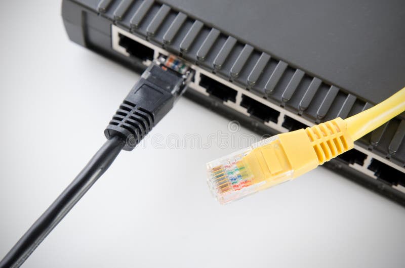 Network switch device and ethernet cables on white stock photography