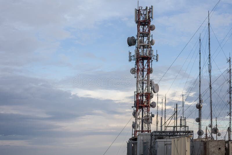 An network tower standing tall near the cliff besides a sandy beach. Dozens of wire connected to each transmission to give supply stock photography An network tower standing tall near the cliff besides a sandy beach. Dozens of wire connected to each transmission to give supply stock photography