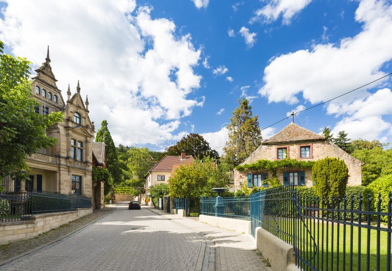 Street with idyllic old mansions in Neustadt an der Weinstrasse, Germany on a clear summer day. Street with idyllic old mansions in Neustadt an der Weinstrasse, Germany on a clear summer day