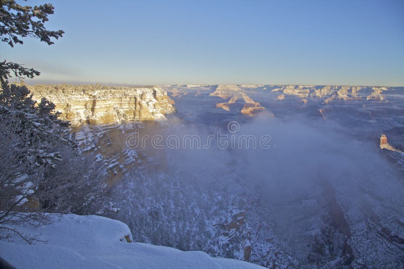 The amazing colorful scenery of the grand canyon's south rim covered in snow in winter. The amazing colorful scenery of the grand canyon's south rim covered in snow in winter