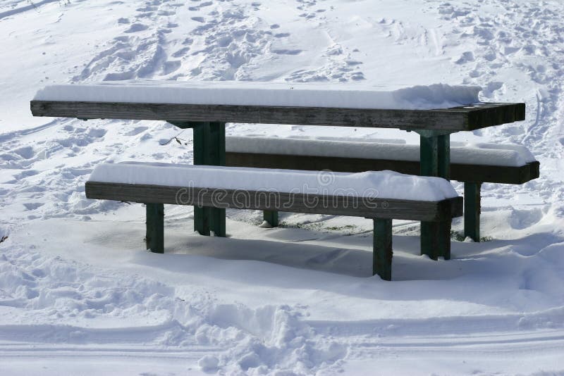 Benches and desk in a park after snow. Benches and desk in a park after snow