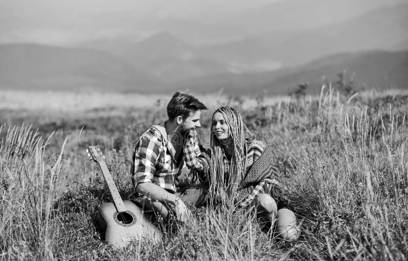 Never boring. friendship. campfire songs. men play guitar for girl. couple in love spend free time together. happy