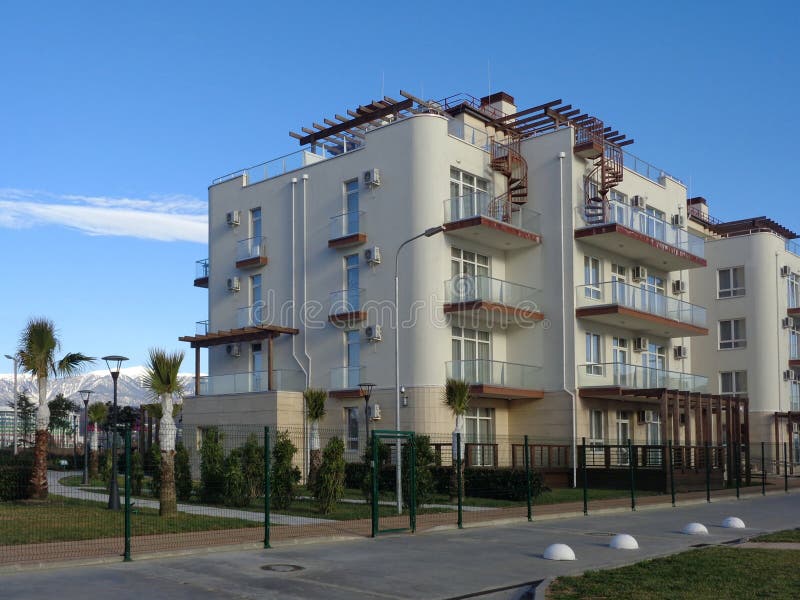 New apartment buildings with green lawn behind fence royalty free stock images New apartment buildings with green lawn behind fence royalty free stock images