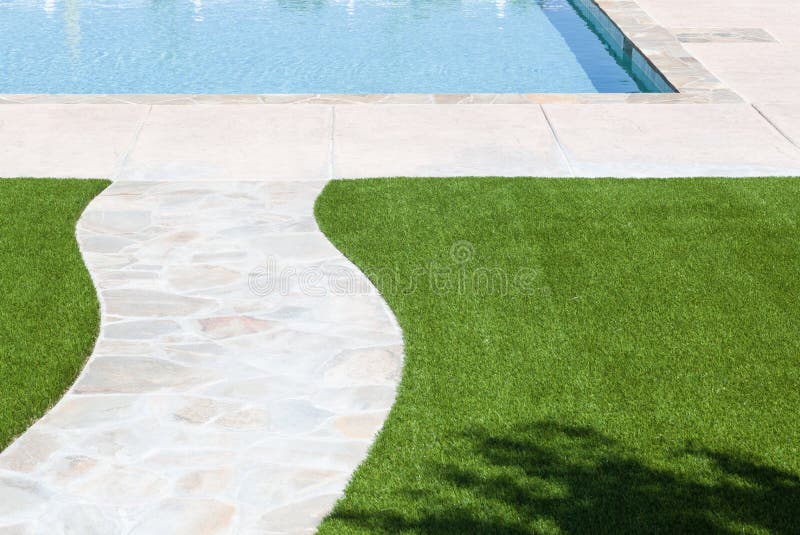 New Artificial Grass Installed Near Walkway and Pool. royalty free stock images