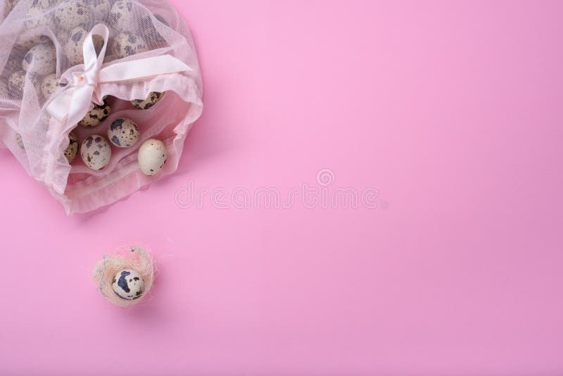 New born child, baby shower or pregnancy greeting card concept. Quail egg in a birds nest over pink background stock image New born child, baby shower or pregnancy greeting card concept. Quail egg in a birds nest over pink background stock image