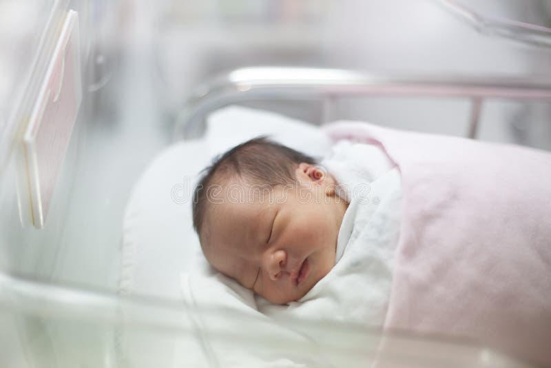 New born infant asleep in the blanket in delivery room stock images New born infant asleep in the blanket in delivery room stock images