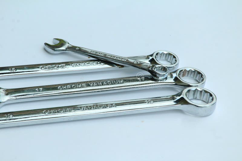 New chrome vanadium wrenchs on white background. Tools for plumbers and motor vehicle mechanics. stock photos