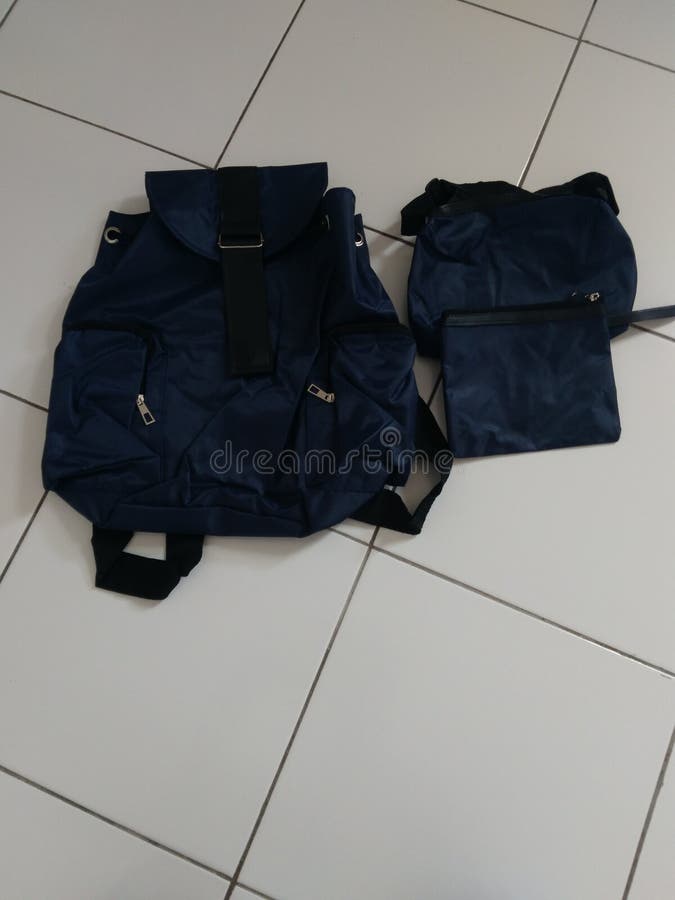 A New Cute Blue Backpack and Purses on the Floor Stock Image Image of