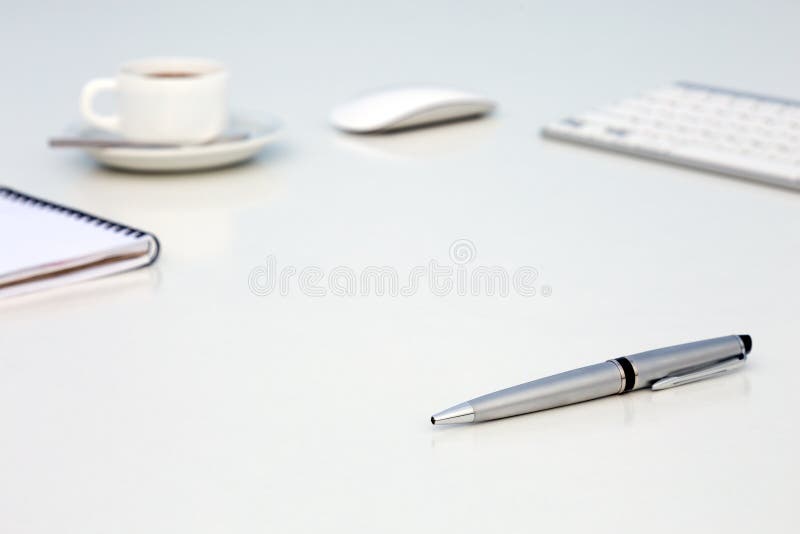 New Day at Office Concept White Table with Computer Blank Notepad and Cup of Coffee Side View stock photo New Day at Office Concept White Table with Computer Blank Notepad and Cup of Coffee Side View stock photo