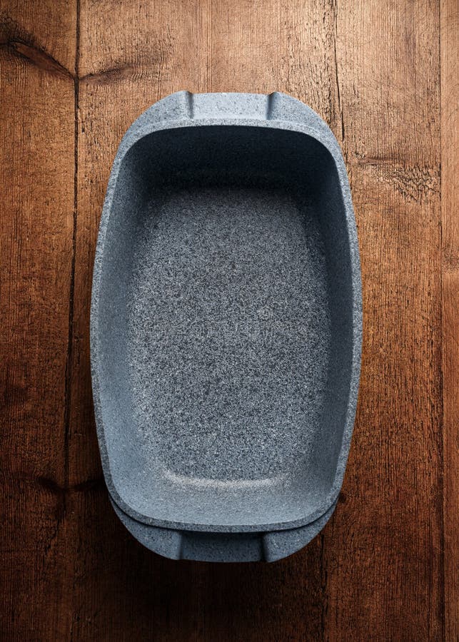 New Deep Oven Roasting White Stone Pan on Rustic Wooden Table Stock