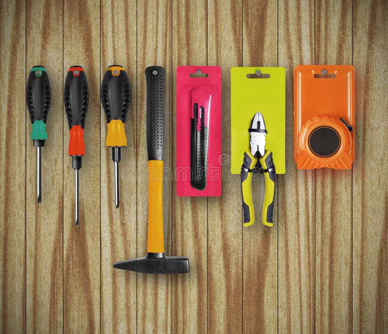 New Different Construction Tools are Hanging on a Wooden Wall Stock
