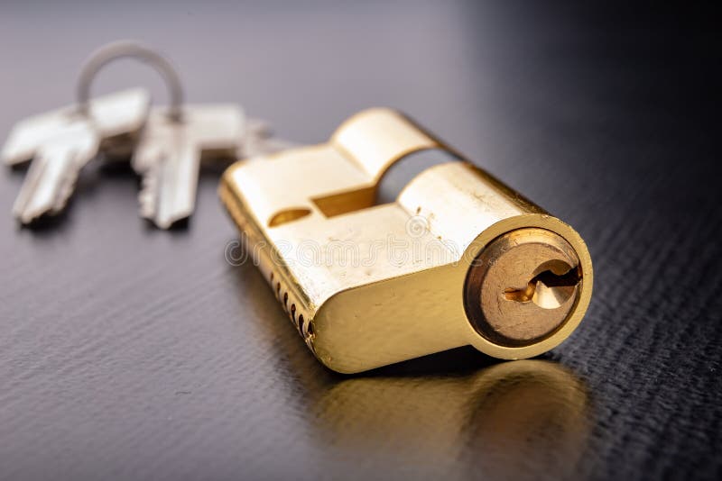A new door lock on a dark background. A patent and keys to secure the front door stock photo