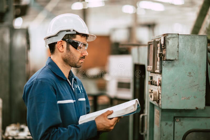 New Engineer Worker Reading User Manual Machine Instruction Guide Book to Working Operate Solving Problem in Metal Factory stock images