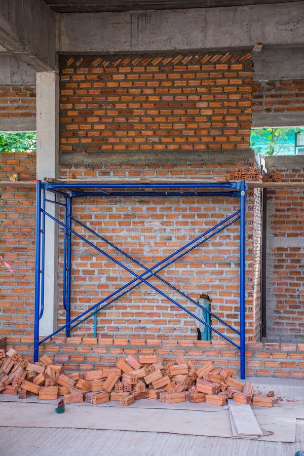 New Interior Red Brick Wall with Scaffolding Under Construction Stock