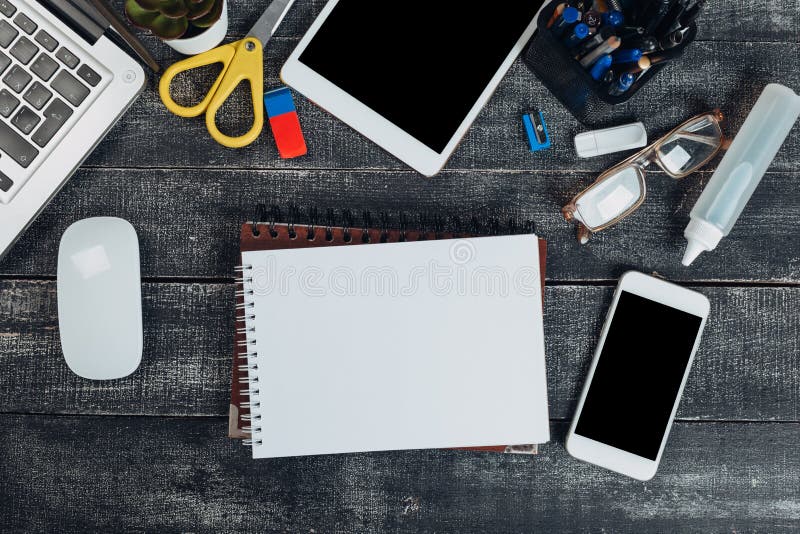 New jobs concept.office stuff with notepad, laptop and coffee cup mouse notepad top view shot stock photography New jobs concept.office stuff with notepad, laptop and coffee cup mouse notepad top view shot stock photography