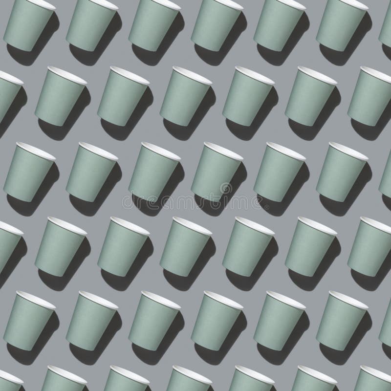 New light green paper cups on a gray top view, hard shadow, pattern, mockup stock photo