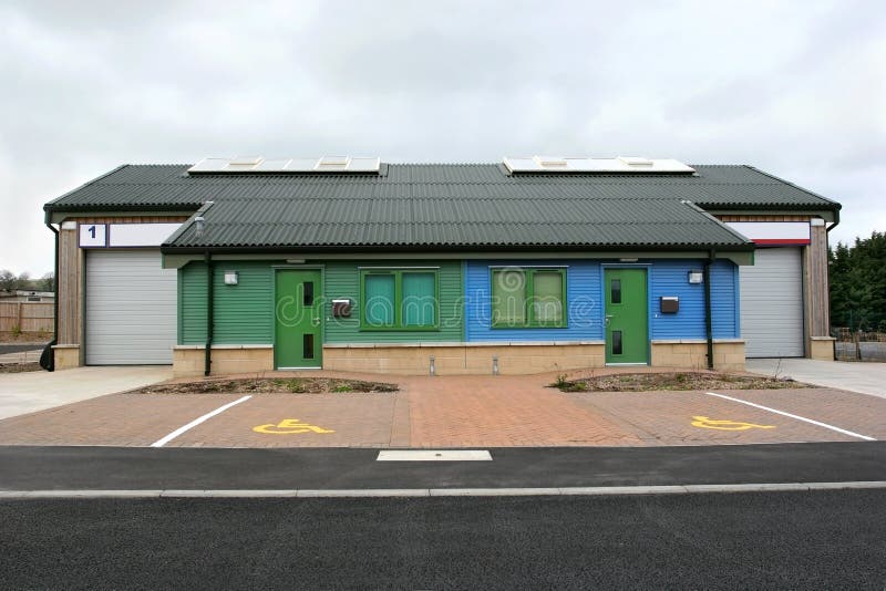 New low level light industrial offices and warehouses with normal and disabled parking and a road in the foreground. Industrial lights stock images, royalty-free photos and pictures