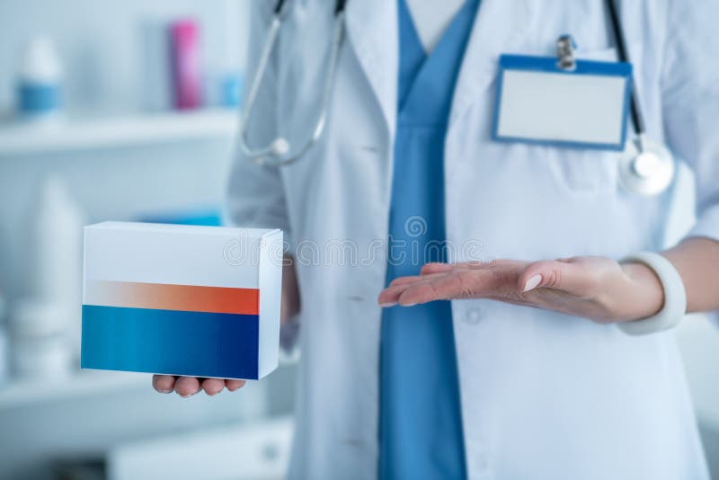Pharmacist in a Lab Coat Showing New Medicine Stock Photo Image of