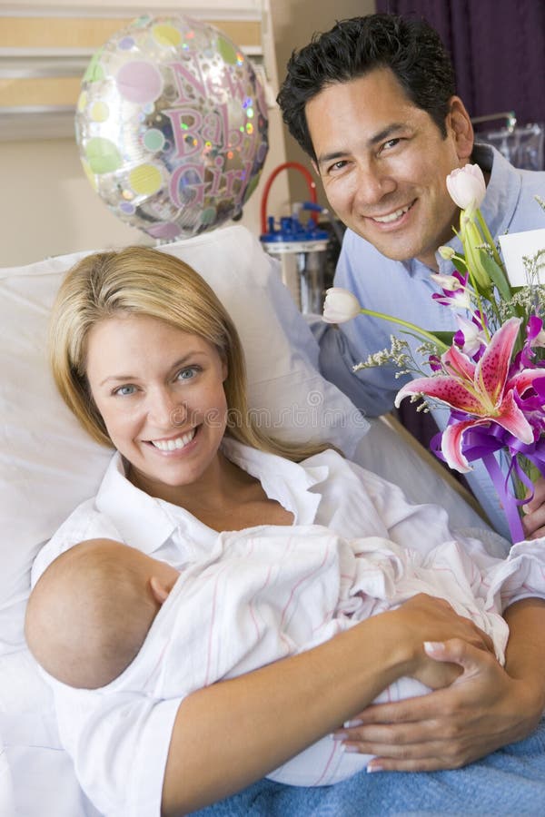 New mother with baby and husband in hospital royalty free stock images New mother with baby and husband in hospital royalty free stock images