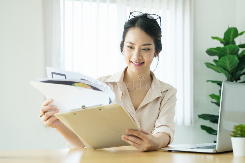 New normal, a businesswoman using computer and open document to work for a company Via the internet on your desk at home stock photography