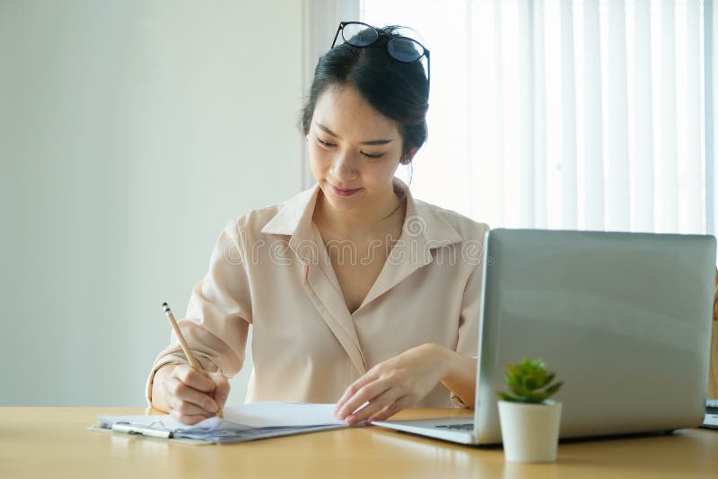 New normal, a businesswoman using notebook and computer to work for a company Via the internet on your desk at home stock photography