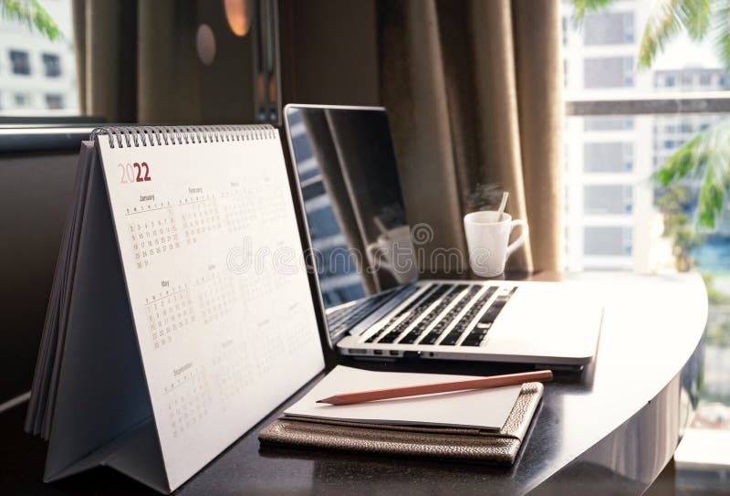 Desktop calendar 2022 on wooden desk in private office