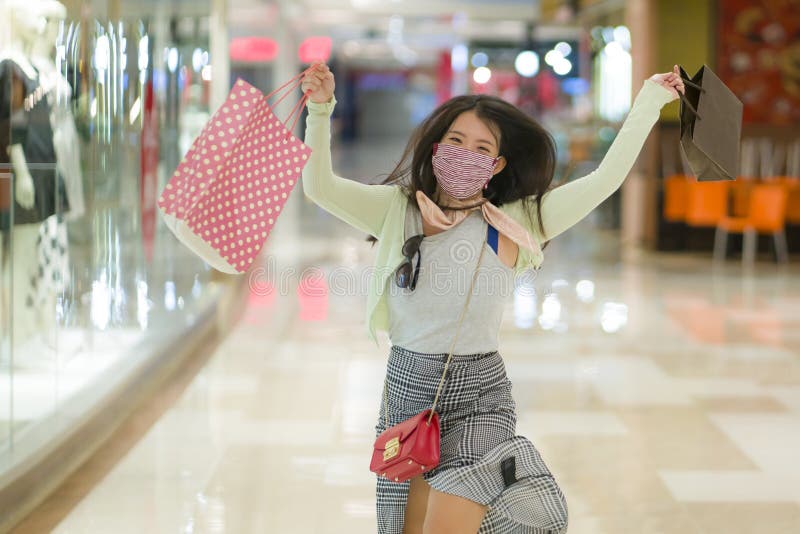 New normal habits - young attractive and happy Asian Korean woman at shopping mall happy and excited enjoying sale in beauty stock images New normal habits - young attractive and happy Asian Korean woman at shopping mall happy and excited enjoying sale in beauty stock images