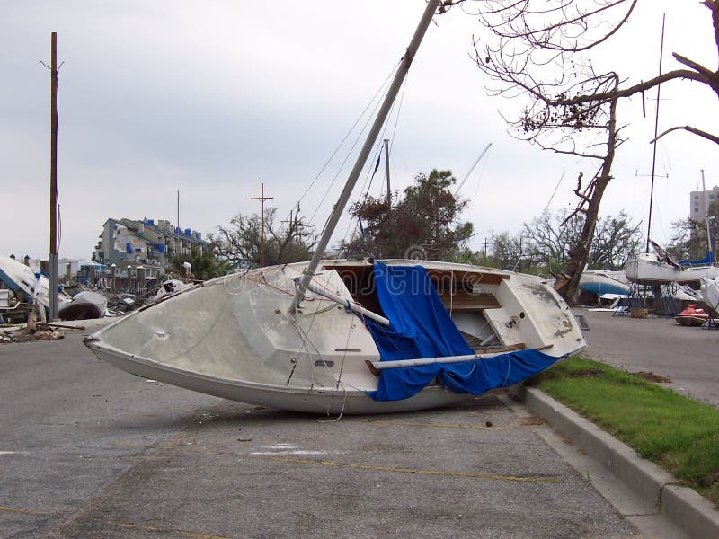 A small sailboat wrecked on a road, thrown inland by Hurricane Katrina stock images A small sailboat wrecked on a road, thrown inland by Hurricane Katrina stock images