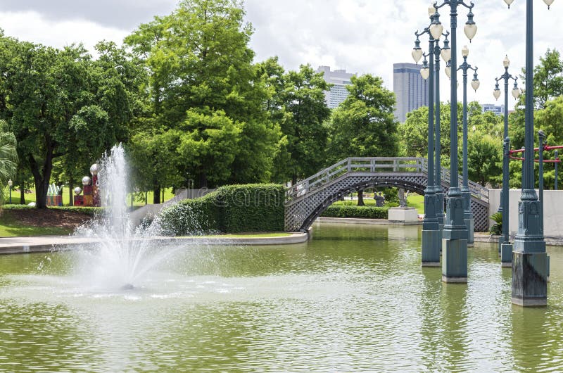 New Orleans Public Park Scenic. New orleans public park with water fountain and pedestrain bridge spanning pond royalty free stock image New Orleans Public Park Scenic. New orleans public park with water fountain and pedestrain bridge spanning pond royalty free stock image