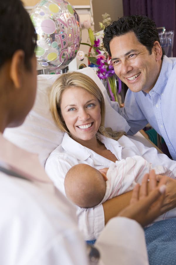 New Parents with Baby Talking To Doctor Stock Image Image of daughter