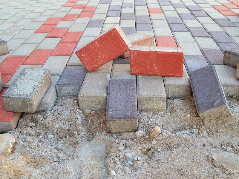 New pavement laying with rectangular paving slabs of gray, blue and red colo stock photos