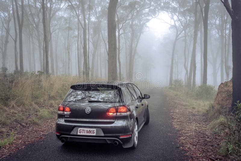 New South Whales, Australia - Volkswagen Golf GTI MKVI parked in a foggy forest.