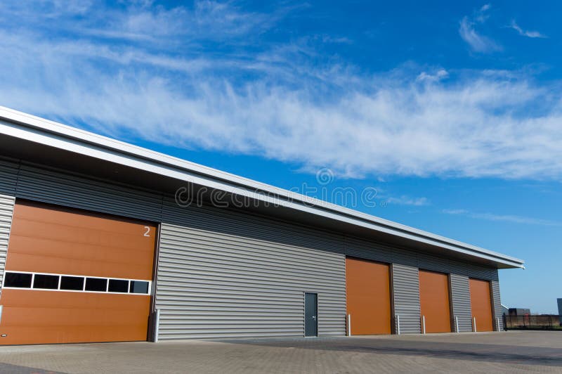 New storage warehouse with brown doors royalty free stock photo