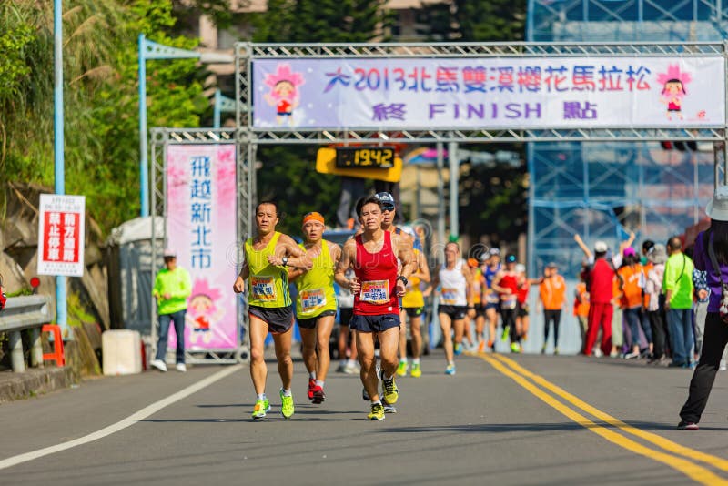 Close Up Shot of People Running in Cherry Blossom Marathon Editorial