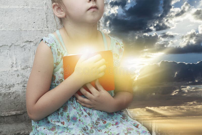 Spiritual education . the prayer book in the child`s hands . Religion background . sacred book. Spiritual education . the prayer book in the child`s hands . Religion background . sacred book