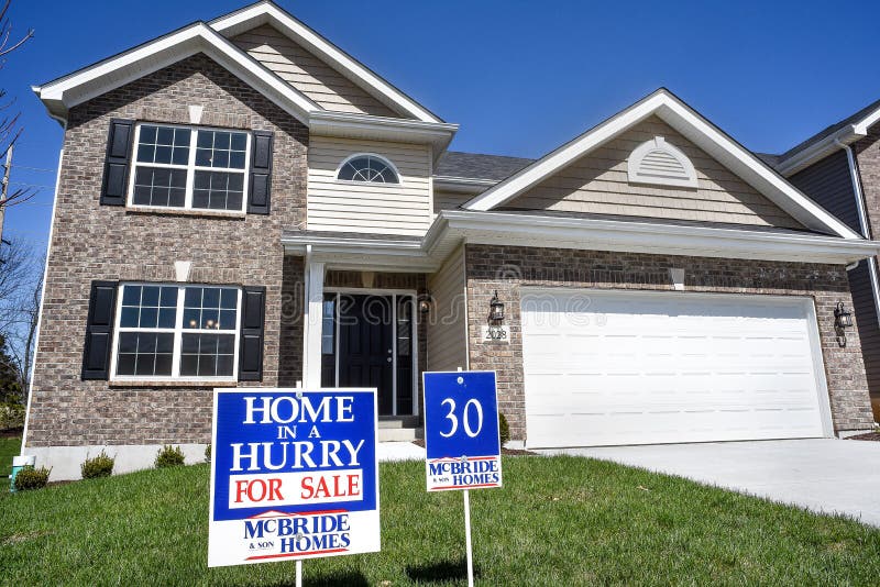 New two-story, brick facade home built by McBride Construction Company for sale sign in yard