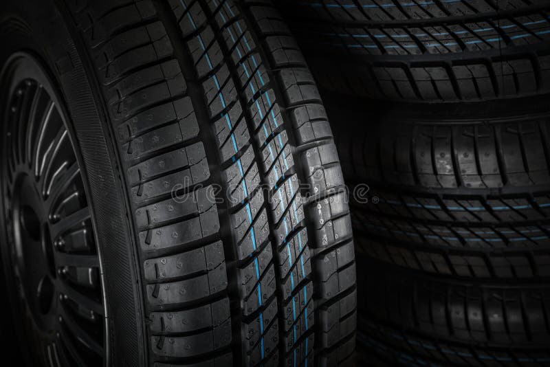 New and unused car tires against dark background