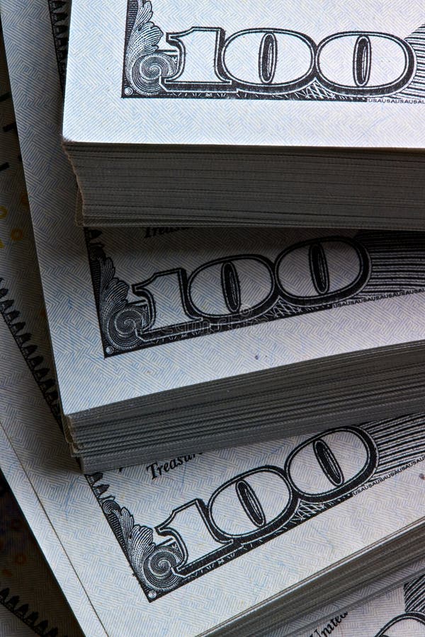 New US Dollar USD 2009 series bill bundles background for design. Many bundle of US 100 dollars bank notes vertical shot royalty free stock images