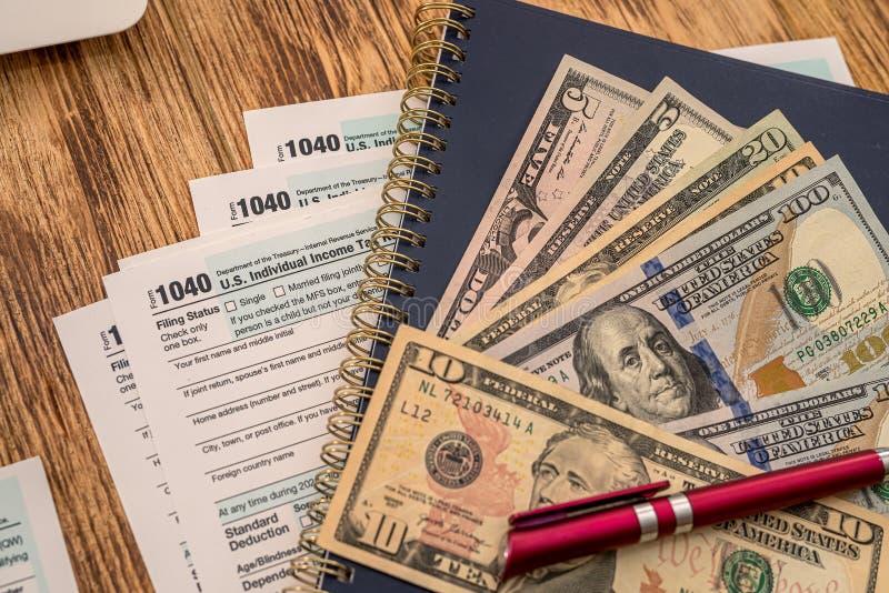the-new-us-1040-tax-forms-feature-dollar-bills-and-a-red-pen-editorial