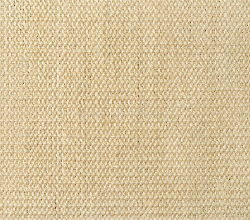 New wicker jute mat texture. Floor covering woven from beige coarse thick fibers. Plain weave backgound. Rustic abstract pattern