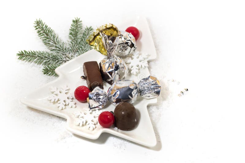 New Year, Christmas holiday card. Ceramic dish Christmas tree chocolate, silver candy stock photo New Year, Christmas holiday card. Ceramic dish Christmas tree chocolate, silver candy stock photo